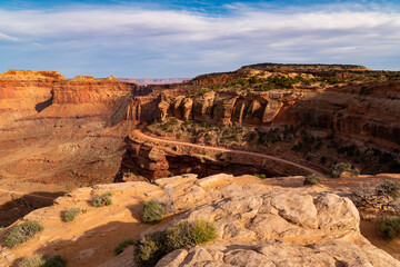 4WD road curves below a canyon rim in Shafer Canyon, Canyonlands National Park, Utah
