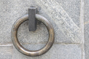 The metal ring in the granite wall symbolizes the chains of non-freedom.