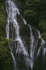 Fototapeta na wymiar Mountain waterfall, Bali landscape, Indonesia. Tourism in Bali.
