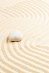 Fototapeta na wymiar zen garden meditation stone background. Stones and lines in the sand for the balance of relaxation and harmony of spirituality or spa health. Natural colors
