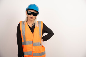 Female builder posing with goggles and helmet