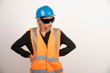 Woman builder posing with goggles and helmet