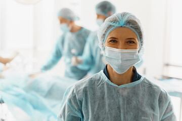 Fototapeta na wymiar Portrait of female surgeon standing in operating room, ready to work on patient