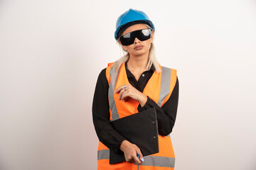 Female engineer in glasses posing on white background