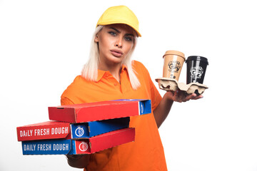 Pizza delivery woman holding pizza and coffees on white background