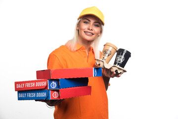 Pizza delivery woman holding pizza and coffees on white background