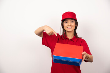 Young smiling woman in red uniform delivering pizza in box