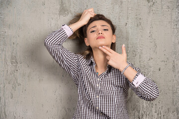 A young pretty woman holding hair in ponytail