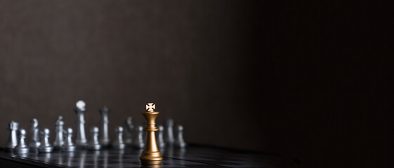 Chess pieces on a chessboard on a dark background
