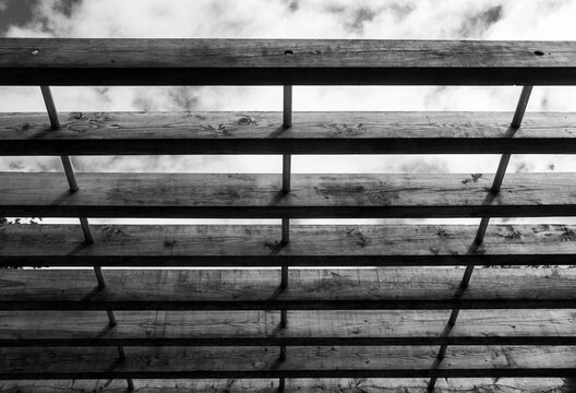 An angle looking up at a wooden decorative roof, black and white image.