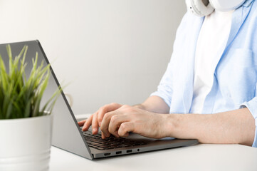 Fototapeta premium Closeup of unrecognizable man typing on laptop. Working or online education
