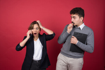 Shocked woman speaking on phone and standing near man with clipboard