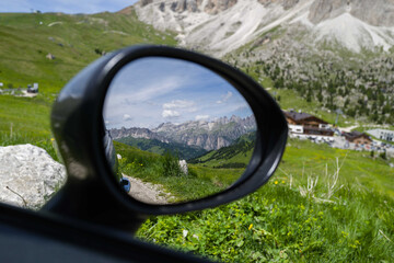 Reflection of the mountain in the car mirror