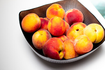 raw peaches in bowl, bowl of fresh peaches on white background