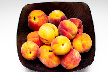 raw peaches in bowl, bowl of fresh peaches on white background