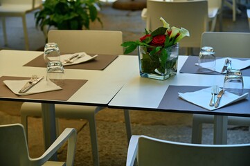 empty restaurant tables set in the terrace waiting customers for dinner