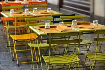 empty restaurant tables set in the terrace waiting customers for dinner