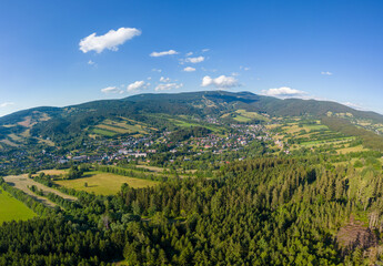 Fototapeta na wymiar Aerial photo of city in middle of mountains