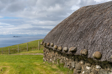 close-up view of a typical crofter cottage with thick stone walls and a thatched reed roof © makasana photo