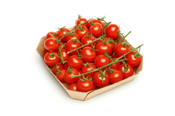 Bunches of fresh red cherry tomatoes in paper box isolated on white background. Ripe tomatoes on...