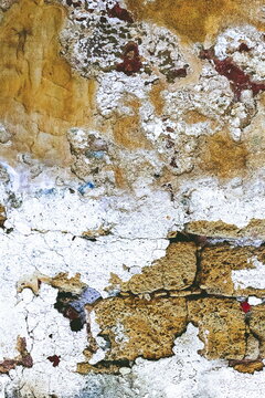 Mixed Grungy Wall Texture with White Сrumbling Plaster. Weathered Distressed Wall Surface. Stonewall Background. Abstract Photo.