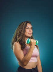 woman in the gym lifting weights and posing for the camera