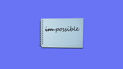 impossible instead possible Hand writing note on a notebook. lifestyle, advice, support motivational positive words are written on a wooden background. Business, signs, symbols, concepts. Copy space.