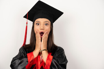 Fresh graduate holding her face with shocked expression on white background