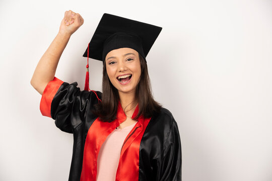 Fresh graduate celebrating her success on white background