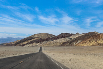 Fototapeta na wymiar Desert Road Leading into the Beautiful Mountains of Death Valley National Park