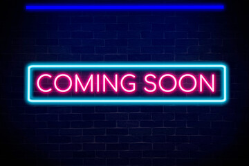 Coming soon neon banner light signboard on brick wall background.