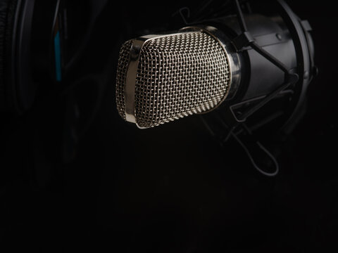 Close-up. Studio microphone on a black background. Minimalism. Monochrome image. Vocal, recording studio, radio, concert, rehearsals. There are no people in the photo.