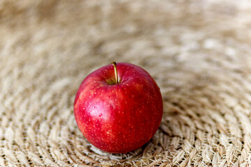 isolated red apple on a table in natural design