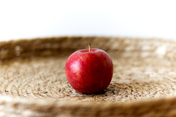 isolated red apple on a table in natural design with space for text
