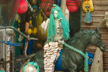 Mermaid on a bronze horse with floats behind