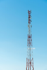 New GSM antennas on a high tower against a blue sky for transmitting a 5g signal are dangerous to health. Radiation pollution of the environment through cell towers. The threat of extinction