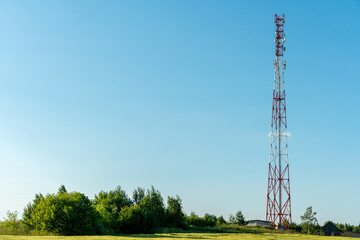 New GSM antennas on a high tower against a blue sky for transmitting a 5g signal are dangerous to health. Radiation pollution of the environment through cell towers. The threat of extinction