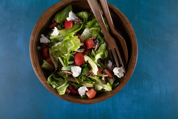 A green textured background with a healthy salad