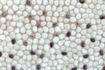 Background of naturally polished white and brown pebbles.