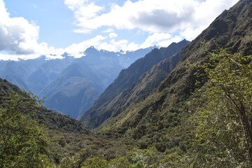 Hiking the green valleys and lush jungle and mountain landscape of the Inca Trail in Peru
