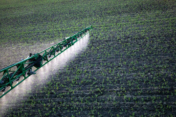 A special tractor sprays the fields from weeds, spraying the fields close-up.