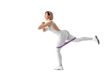 Sexy woman in sportswear using a resistance band in her exercise routine. Young woman performs fitness exercises on white background. Isolate