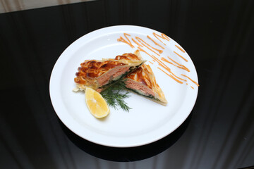 delicious appetizing food dish   meat cake roll pie on a plate in a restaurant