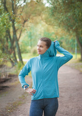 Beautiful fitness woman runner in the blue hoodie