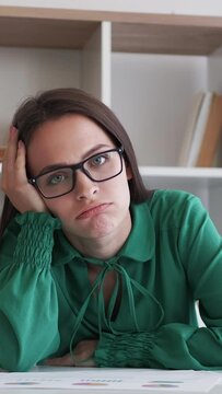 Vertical video. Disappointed business woman. Meeting online. Boring interview. Work dismissal. Upset female employee got fired leaving home office workplace.