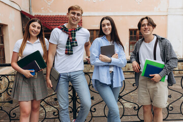 Study together is fun, teamwork, team building concept. Four happy students are sitting near...