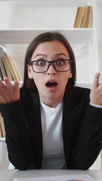 Vertical video. Annoyed business woman. Web chat. Project failure. Shocked frustrated female leader listening bad statistics report clutching head at virtual home office.
