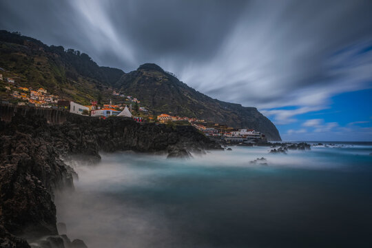 Beautiful nature landscape with Atlantic Ocean and lava rock natural swimming pools in Porto Moniz, Madeira, Portugal. Long exposure picture, october 2021