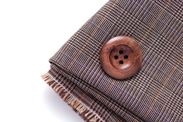 Button at folded fabric on white  background. Creative tailor concept