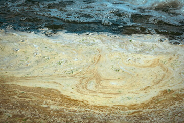 Fototapeta na wymiar Yellow foam surface reservoir, pollution rivers with chemicals and industrial waste.